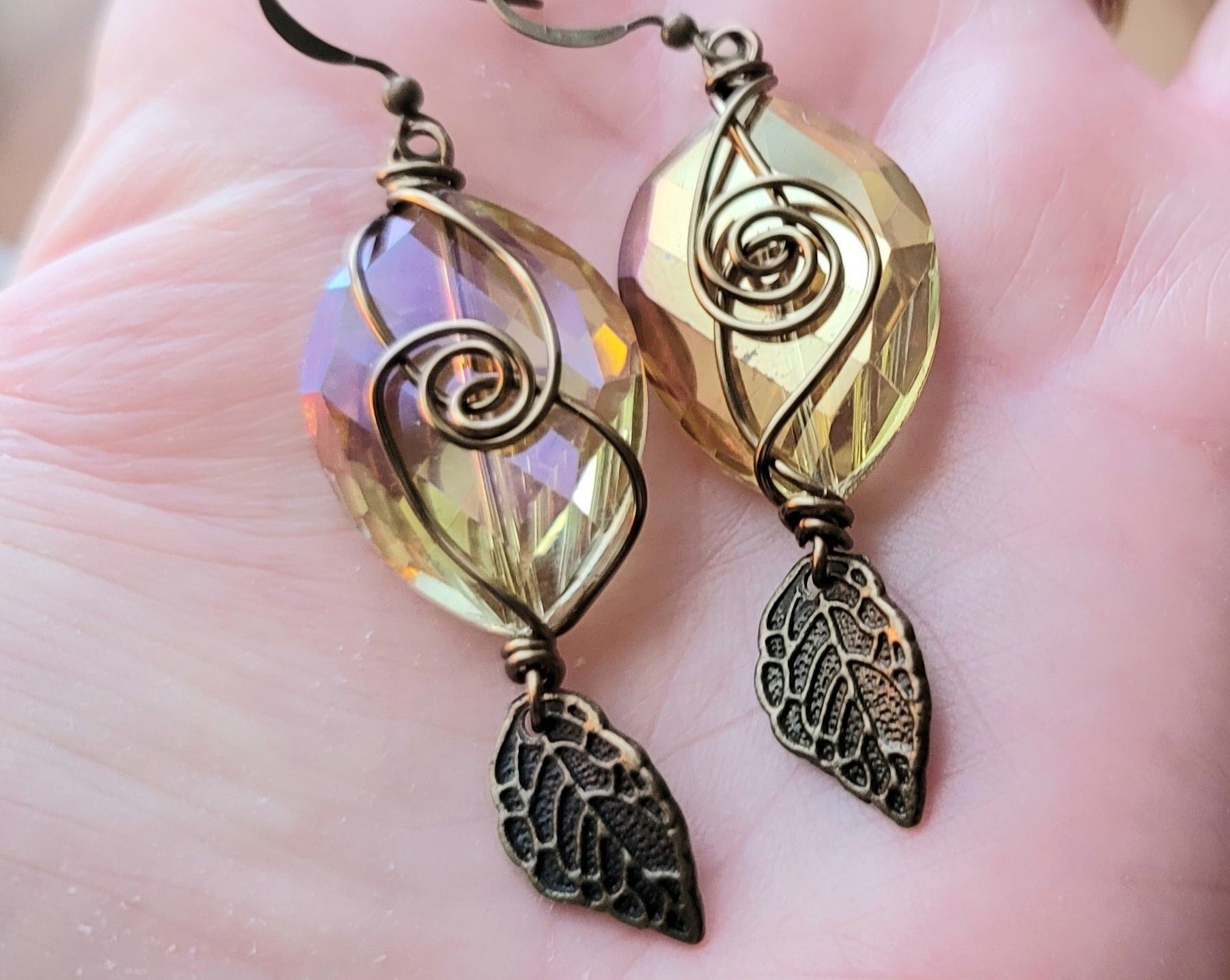 Long Brilliant Boho Crystal Leaf Earrings with large faceted oval shaped citrine/yellow color crystal and antiqued brass plated leaf and wire word. 