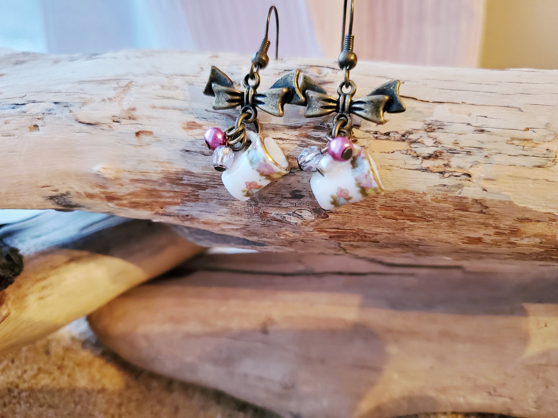 Shabby Chic, Vintage Coffee Cup Earrings displayed on beach wood