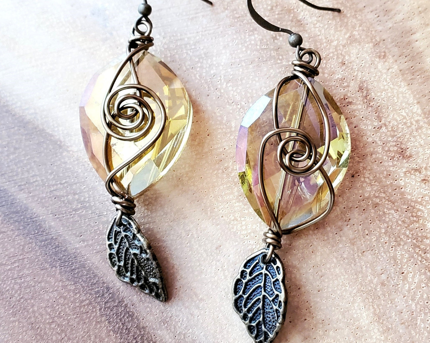 Long Brilliant Boho Crystal Leaf Earrings with large faceted oval shaped citrine/yellow color crystal and antiqued brass plated leaf and wire word. 