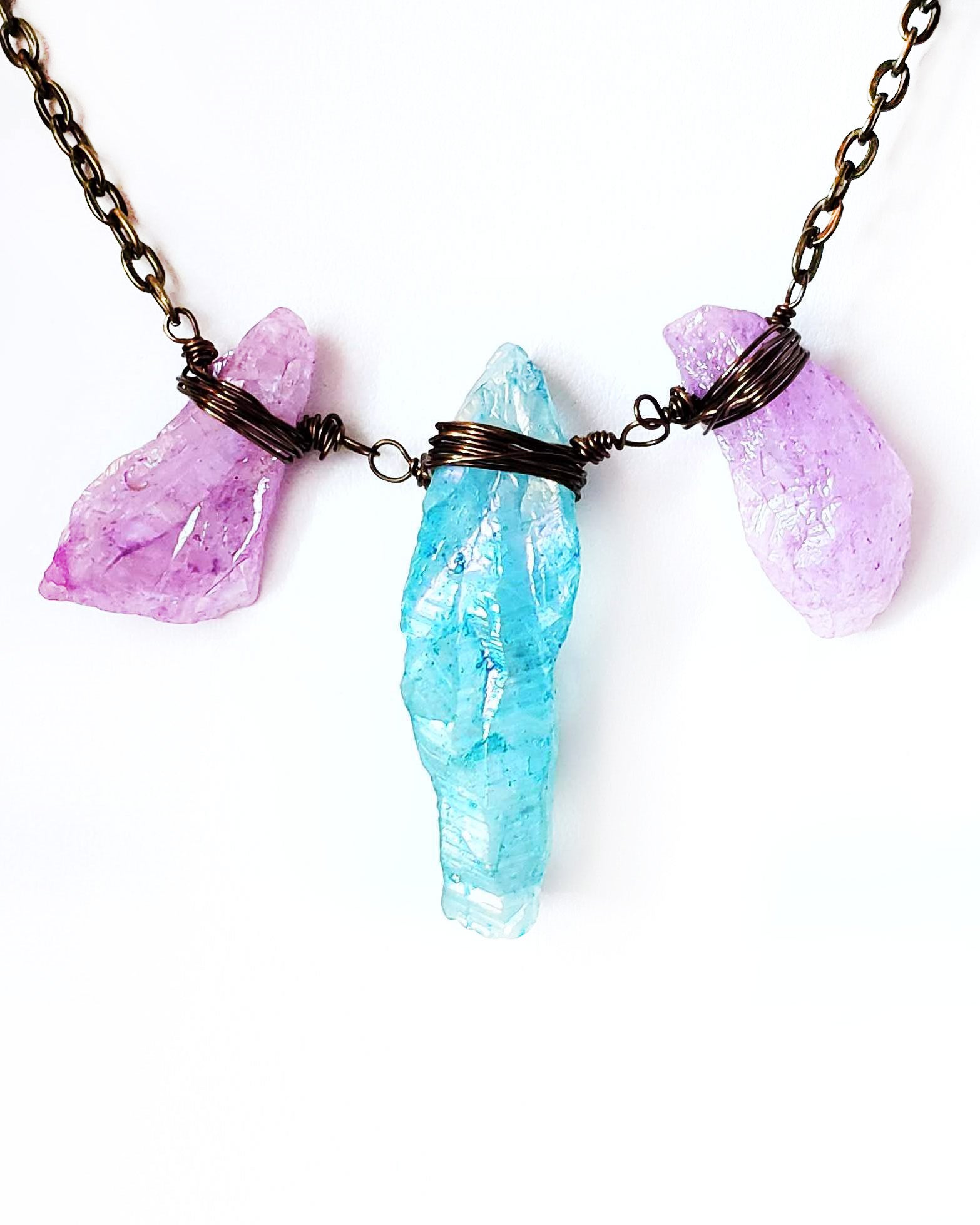 Lavender Blue Rainbow Quartz Crystal Necklace-Antiqued Brass Wire Wrapped Crystals on Chain displayed on white background 