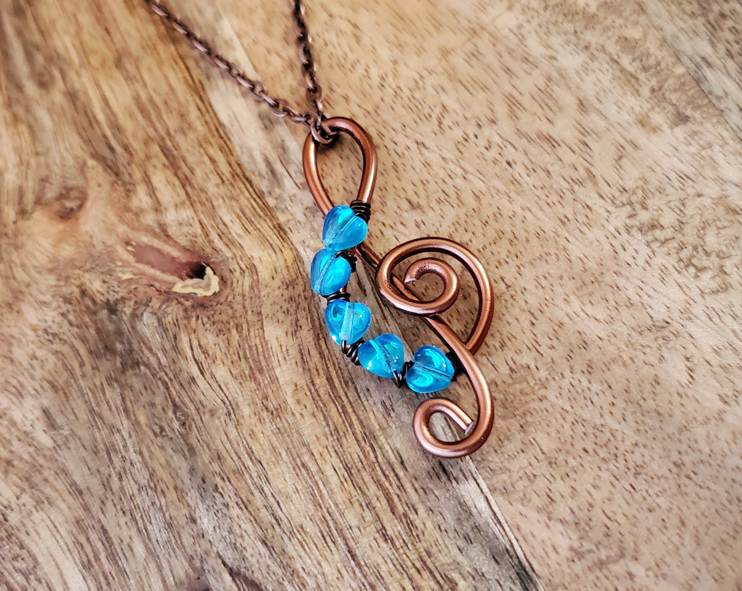 I Love the Blues Treble Cleft Blue Heart Pendant Necklace, Five Tiny Aqua Blue Glass Hearts and an Antique Copper Treble Cleft Pendant on chain.