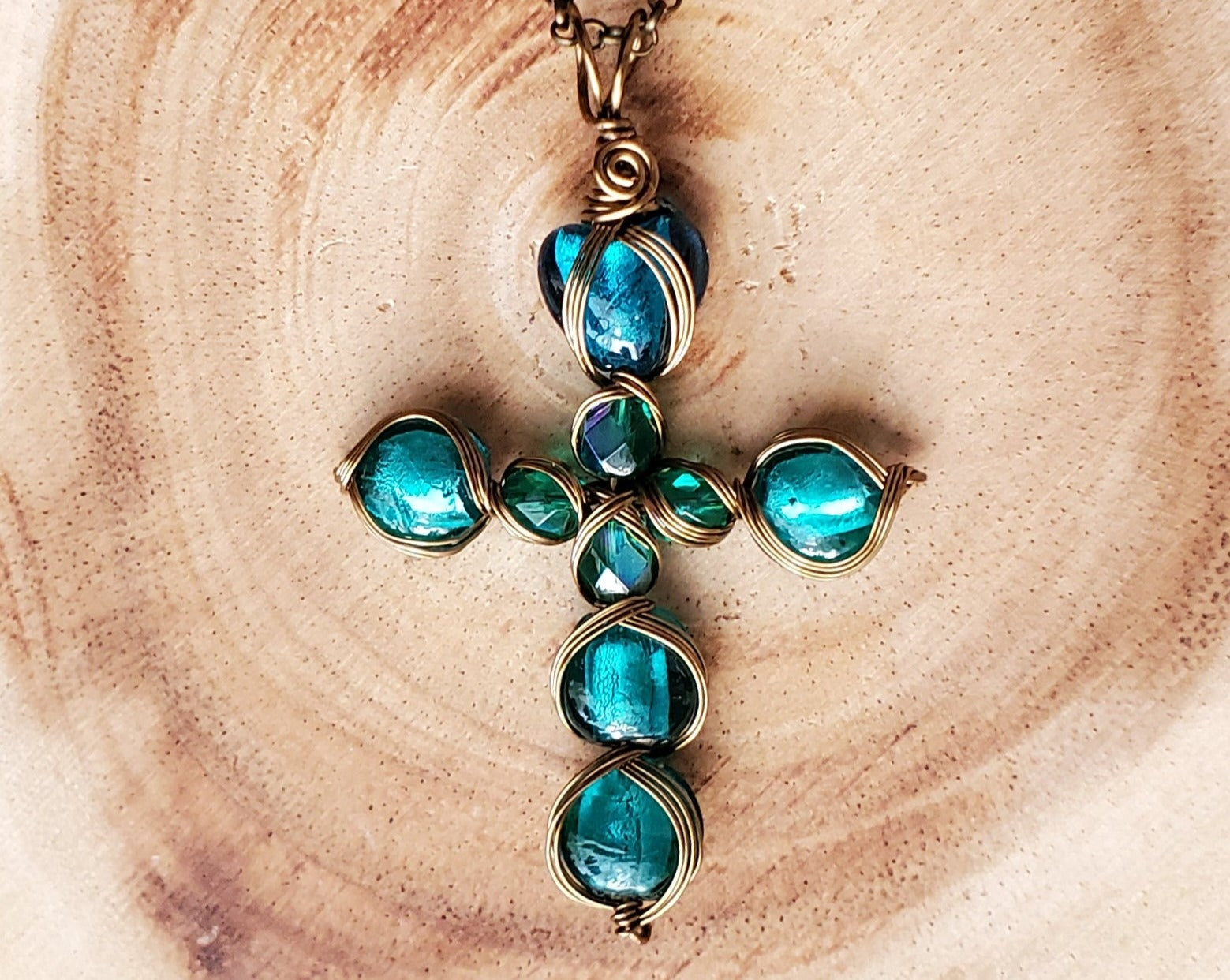Luminous Teal Foil Glass Cross Pendant, Antiqued Brass, Luminous Teal green glass beads and heart