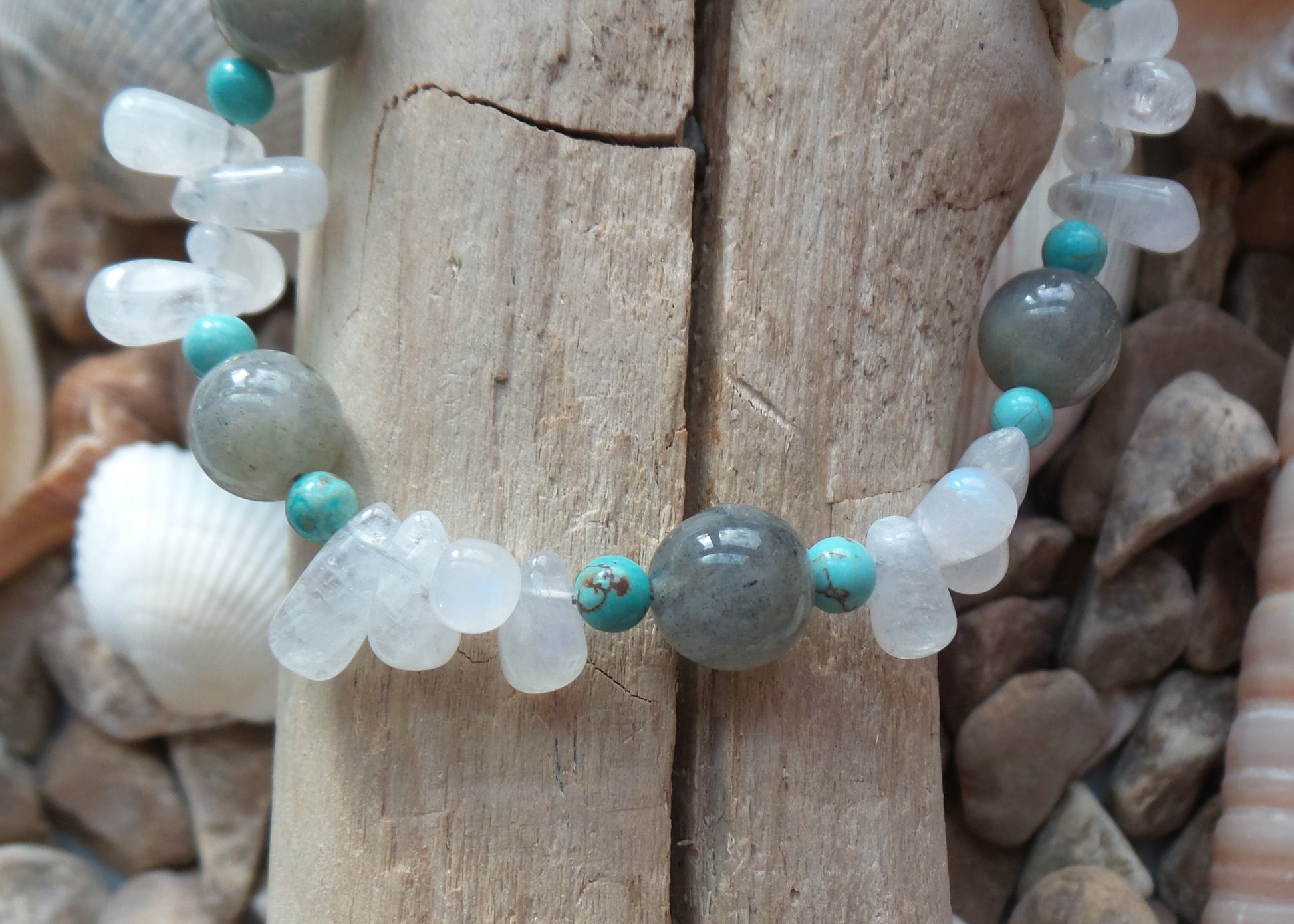 Moonstone Labradorite Turquoise Beaded Gemstone Bracelet with Sterling Silver lobster claw clasp, on Beach Wood background 