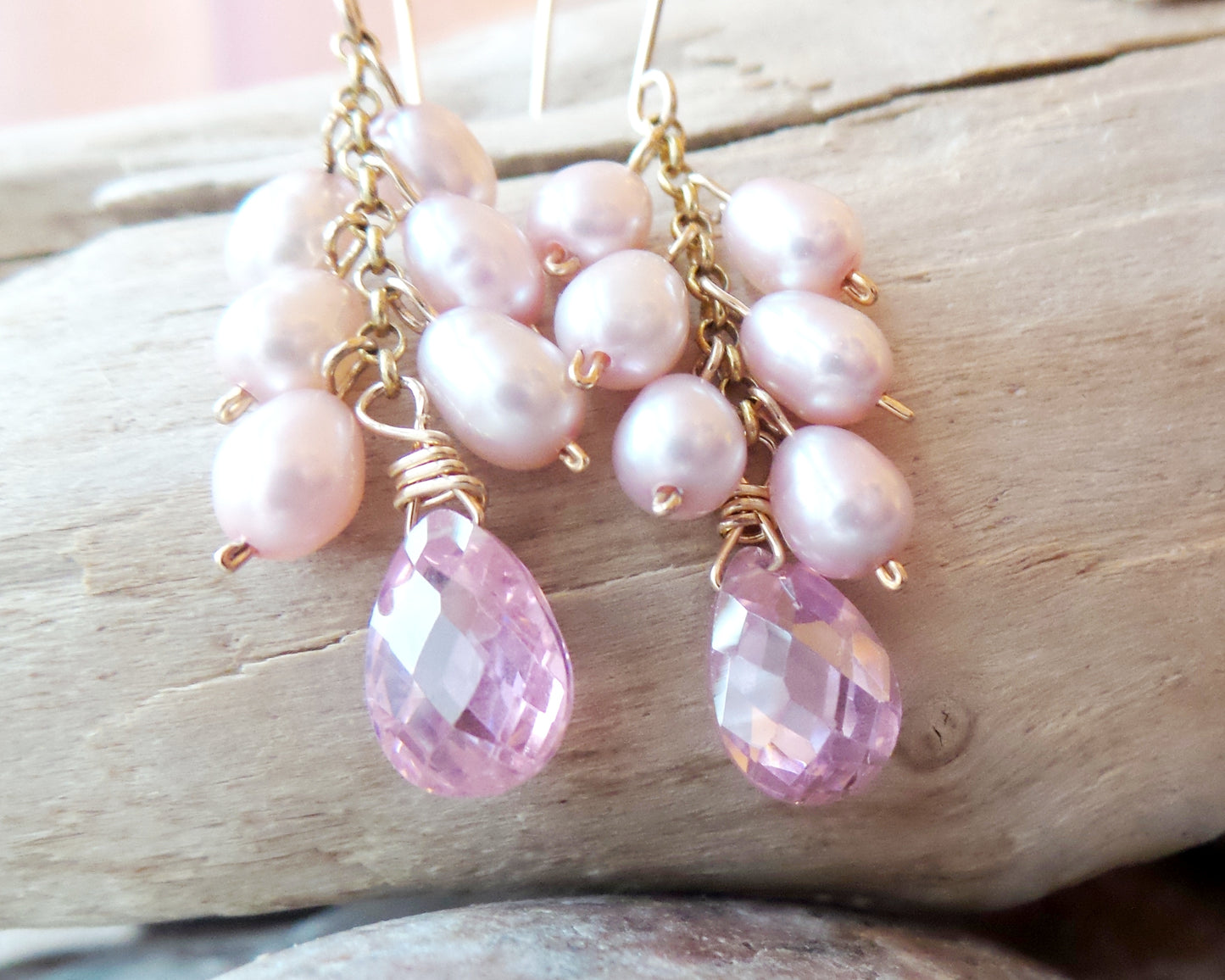 Long Pink Pearl Cubic Zirconia Cluster Earrings, handmade with faceted, drop shaped Cubic Zirconia and a long cluster of dangling pink Freshwater Cultured Pearls. 