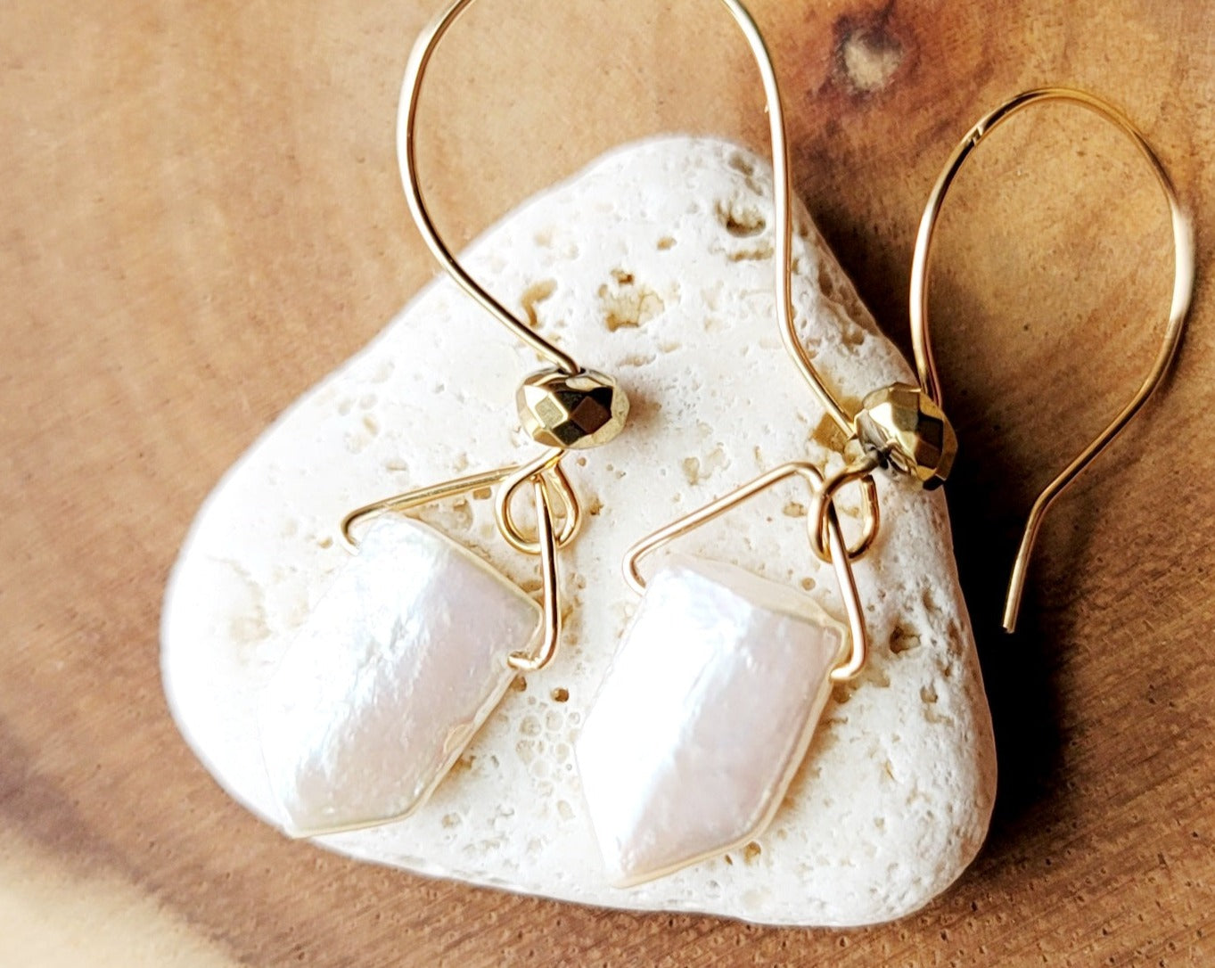 Follow Your Dreams Pearl Arrow Earrings, 14k Gold Filled, Genuine Freshwater Cultured Pearl Arrows, sparkly gold plated Hematite. Displayed on Stone