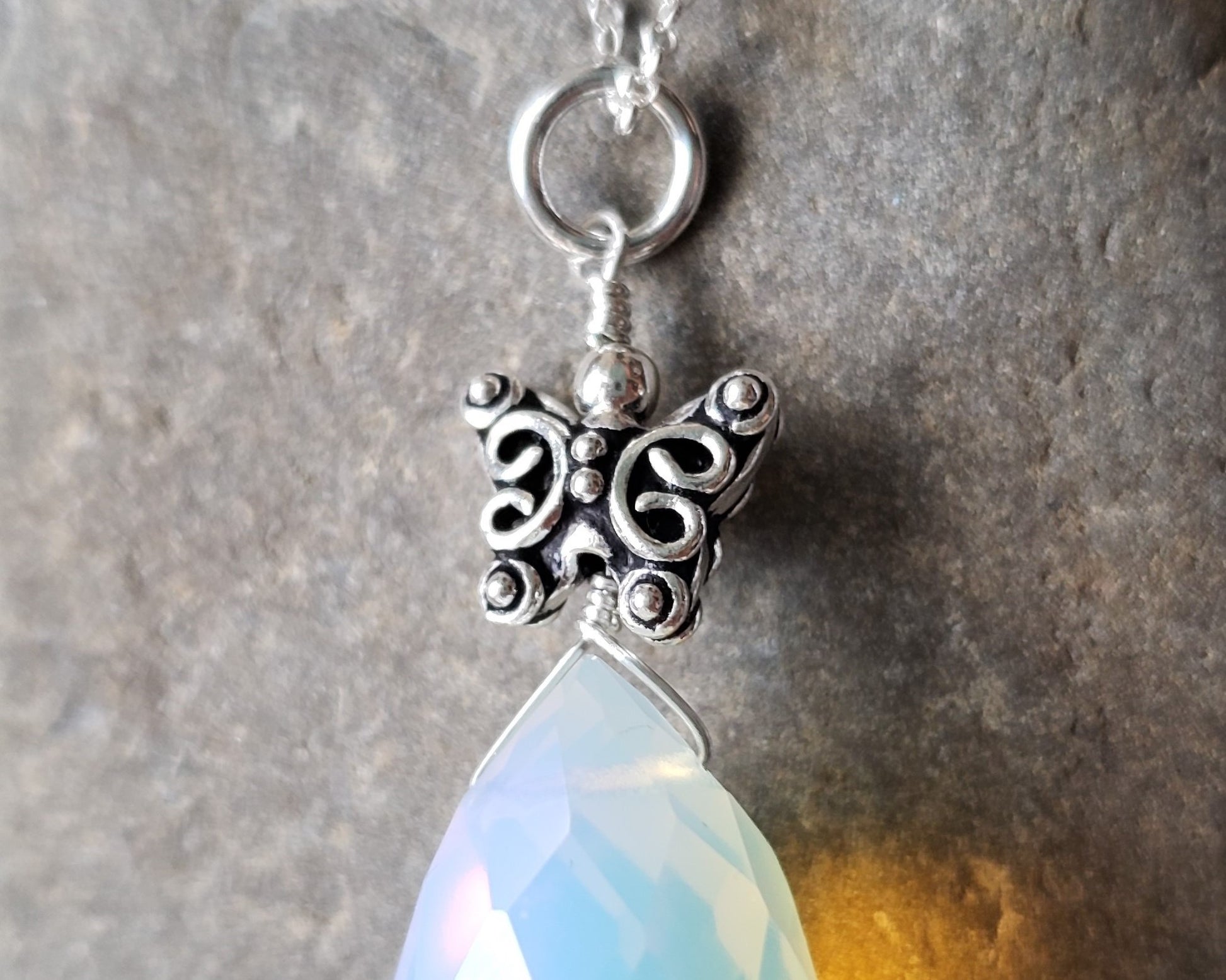 Butterfly Opal Dreams Pendant, Butterfly on top of Large Opalite Drop shape stone, pendant on chain. 