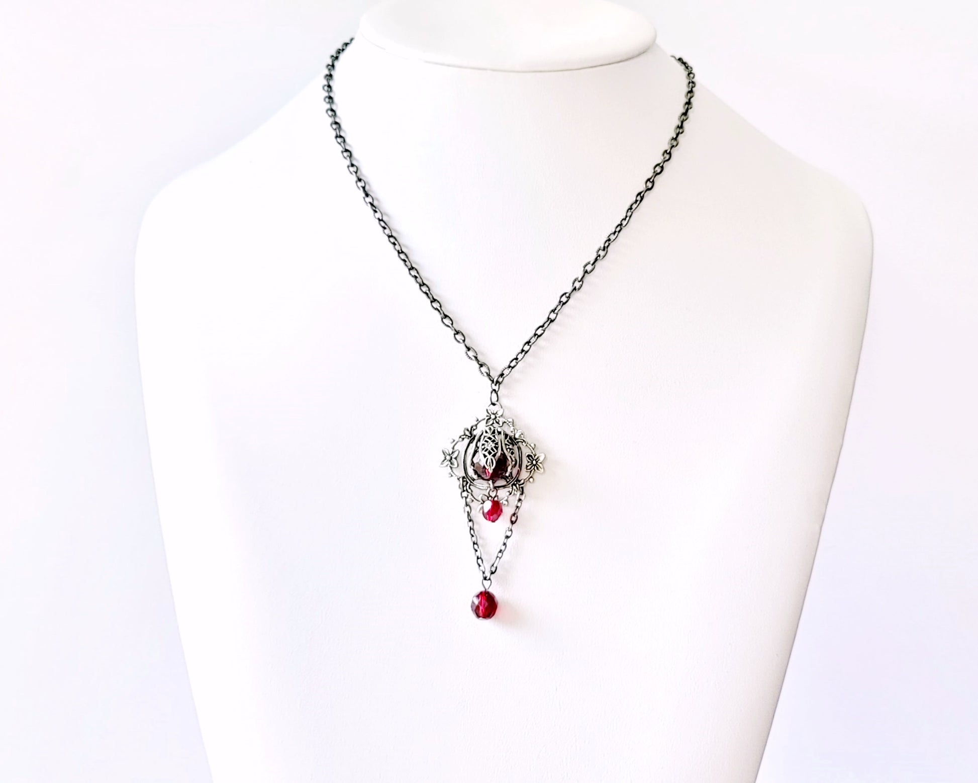 Victorian Garnet Flower Fire Necklace, Vintage Style, Garnet Red, Black Metal necklace on white display 