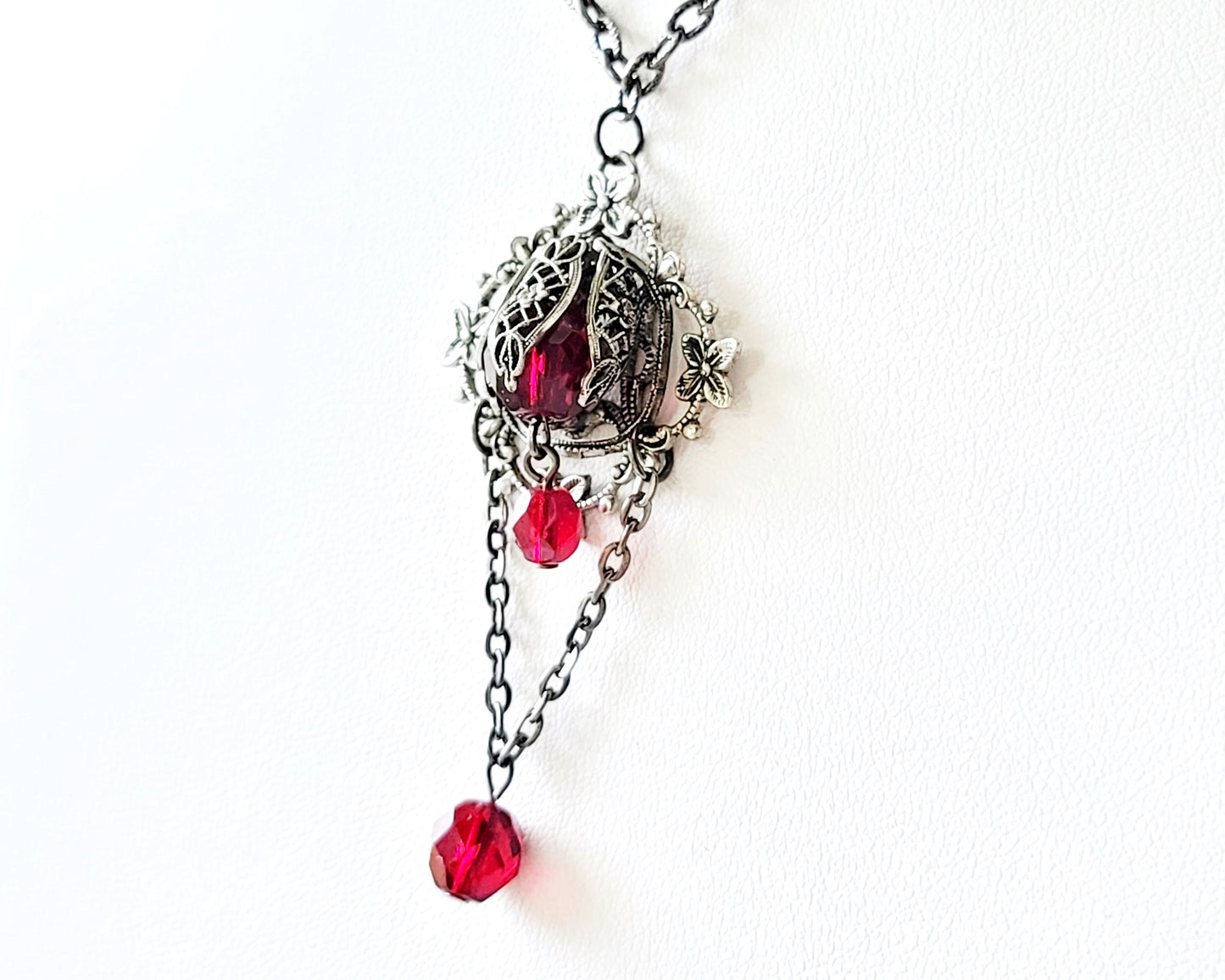 Victorian Garnet Flower Fire Necklace, Vintage Style, Garnet Red, Black Metal necklace on white display 