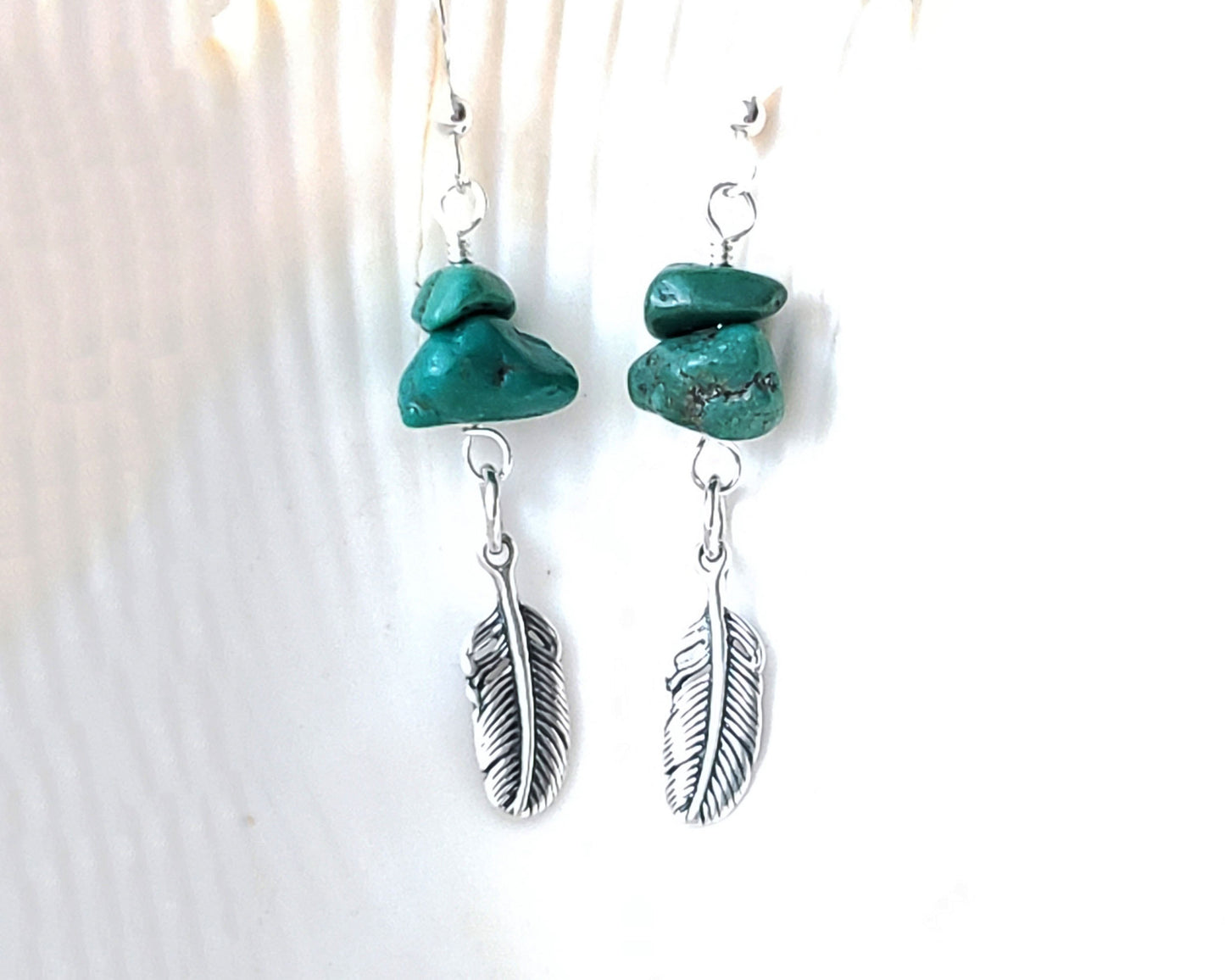 Turquoise Feather dangle earrings with rare, deep greenish vintage turquoise nuggets & sterling silver feather pendants with shell background