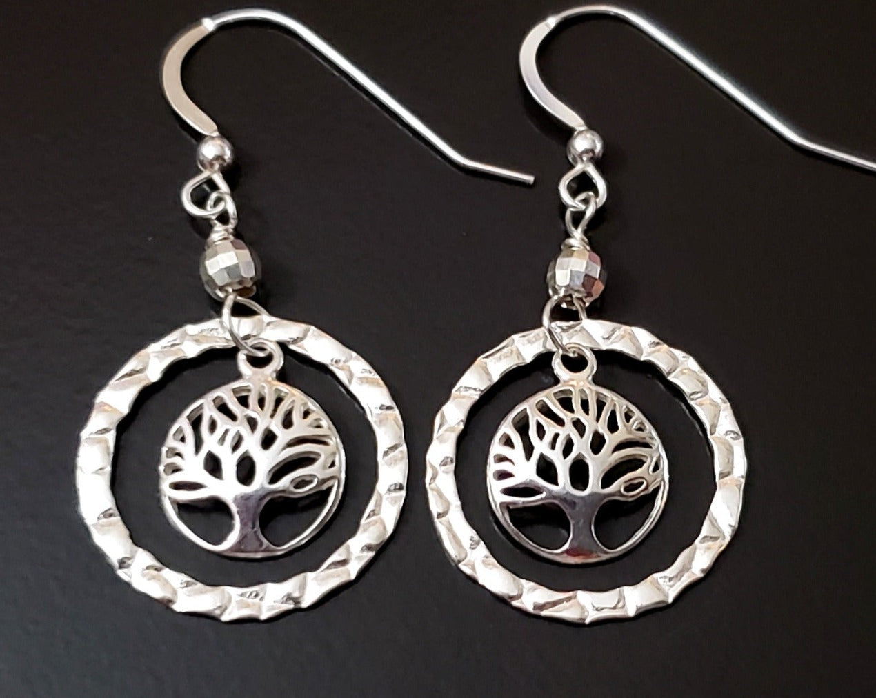 Long Sterling Silver Tree of Life Eternity Earrings. Tree of Life pendants dangle inside textured Eternity Rings