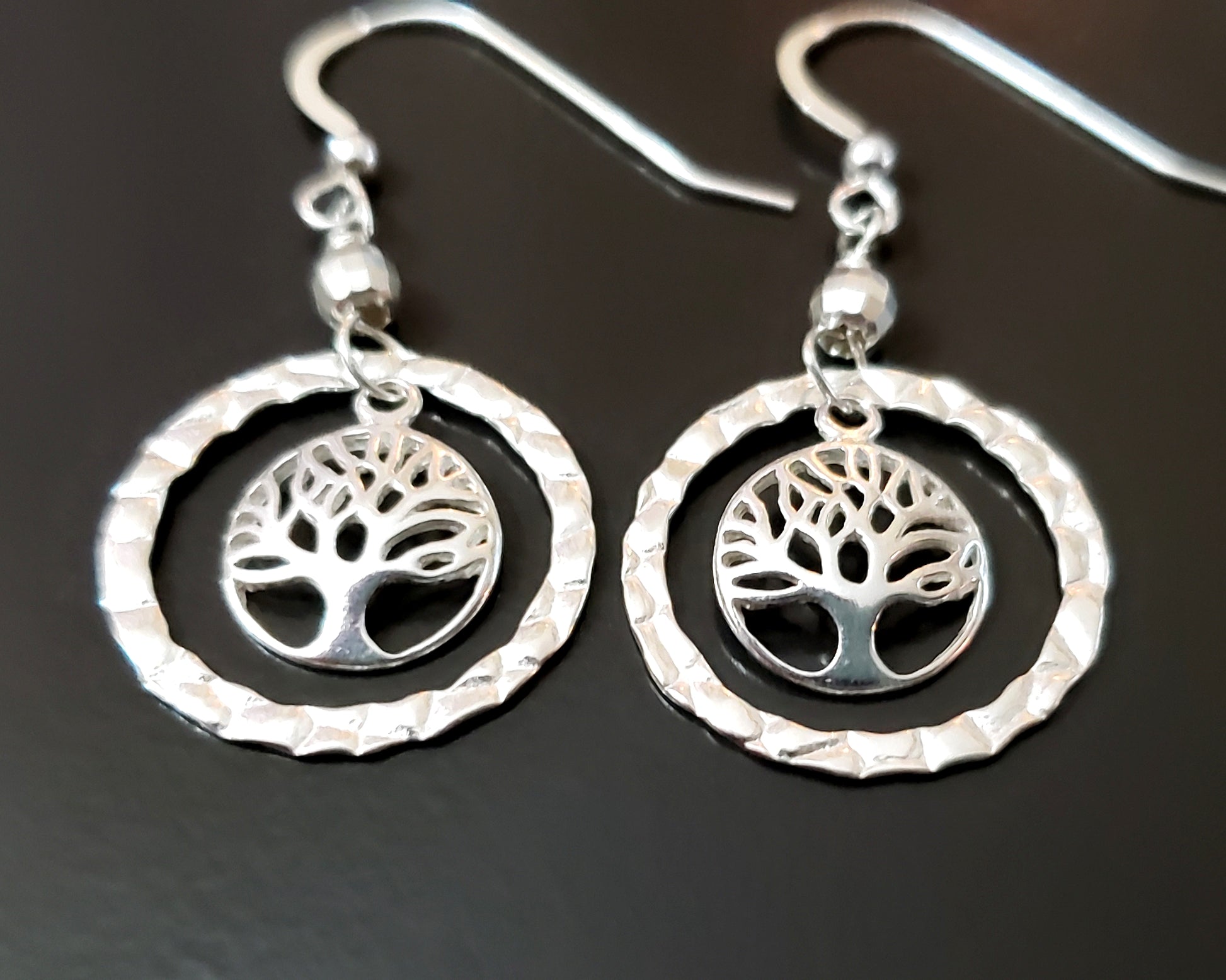 Long Sterling Silver Tree of Life Eternity Earrings. Tree of Life pendants dangle inside textured Eternity Rings