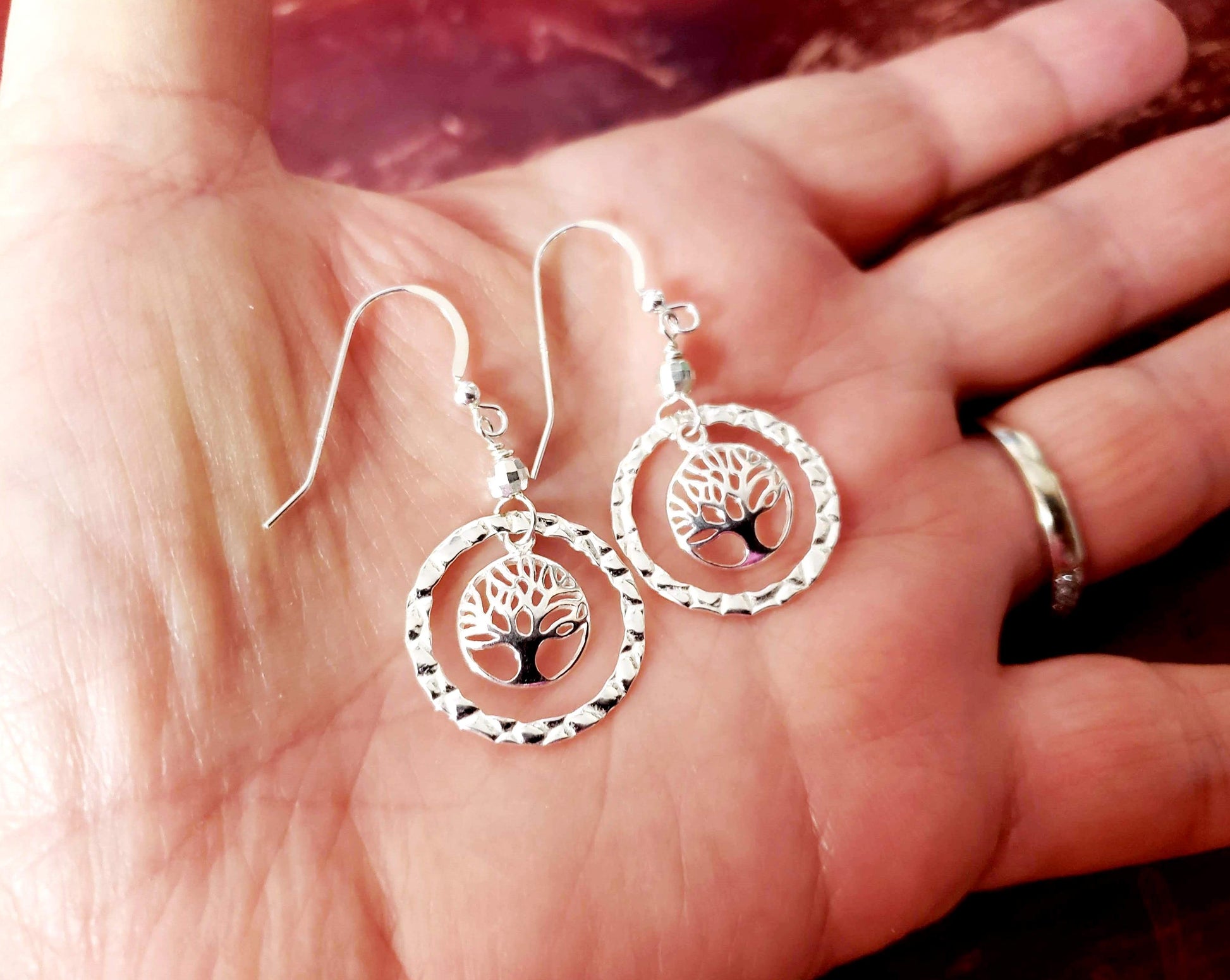 Long Sterling Silver Tree of Life Eternity Earrings. Tree of Life pendants dangle inside textured Eternity Rings