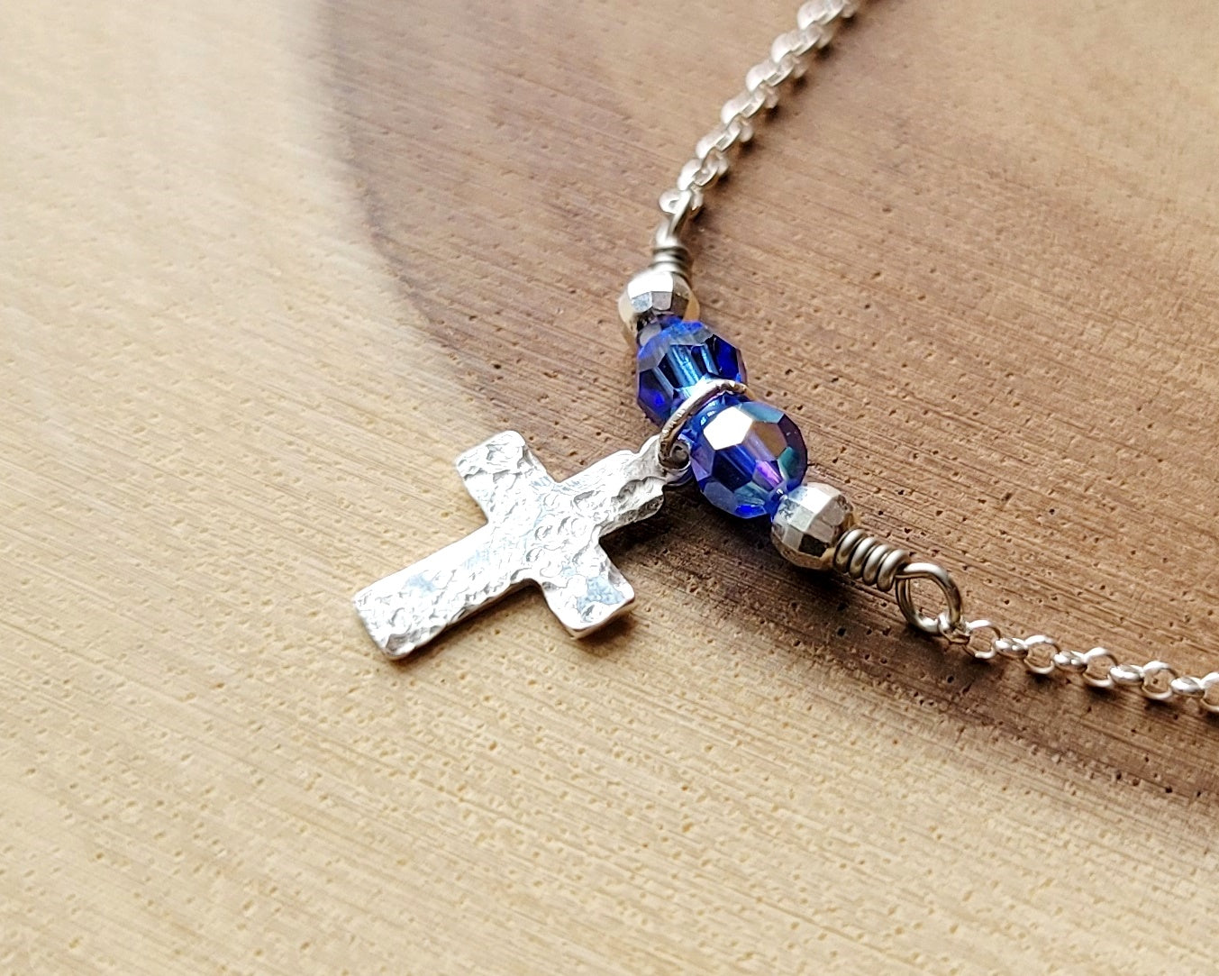 Sterling Silver Cross with small birthstone color crystals on either side, on a fine sterling silver fine Rolo Chain.